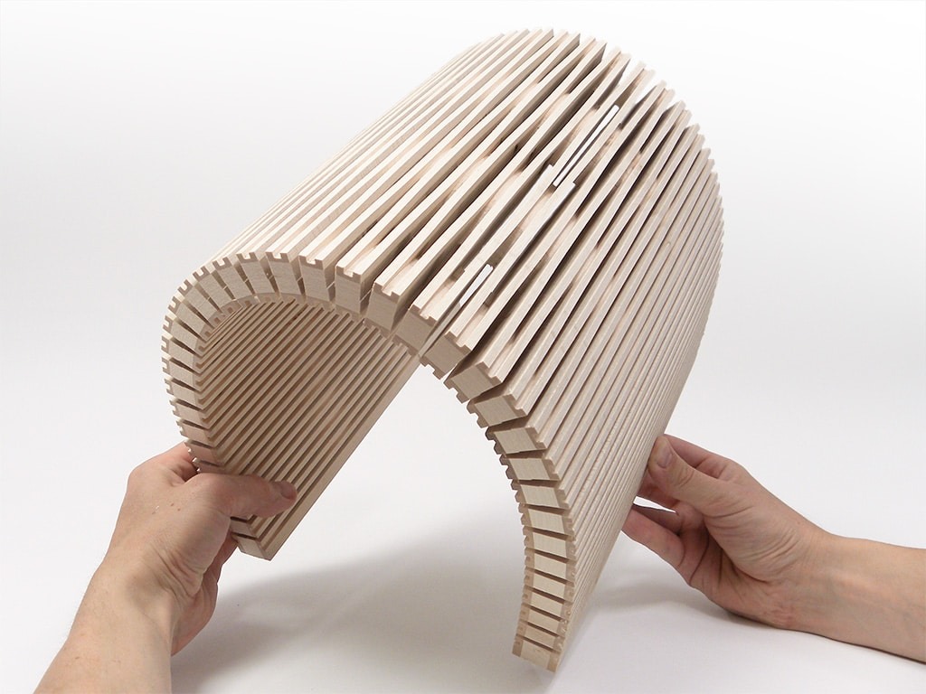 SchmittCo - flexible wood acoustic partition walls - JANUS maple sample in hand